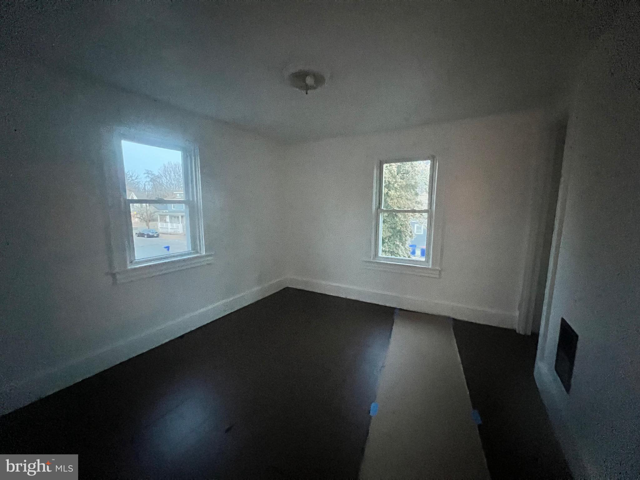 302 West Main Street Millville, NJ 08332 - Photo 21 of 22 a view of an empty room with wooden floor and a window