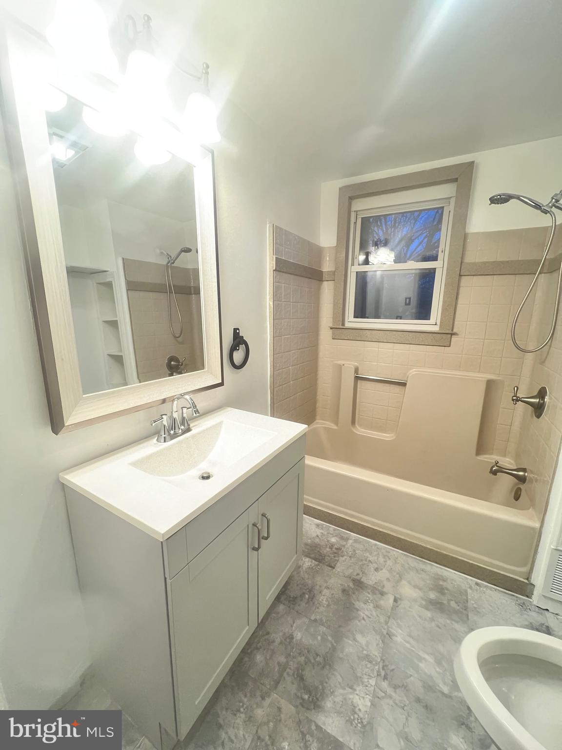 302 West Main Street Millville, NJ 08332 - Photo 10 of 22 a bathroom with a sink a toilet and a mirror