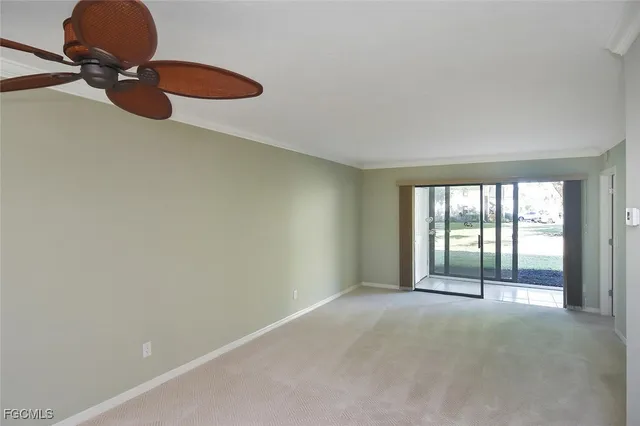 a kitchen with a refrigerator and white cabinets