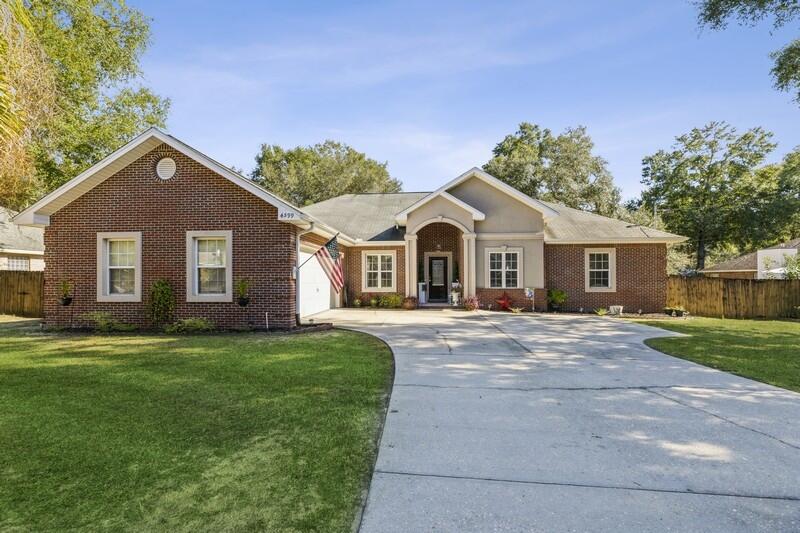 4599 Live Oak Church Road Crestview, FL 32539 - Photo 1 of 34 a front view of a house with a garden