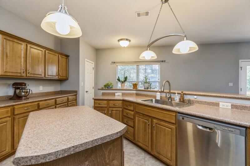 4599 Live Oak Church Road Crestview, FL 32539 - Photo 11 of 34 a kitchen with kitchen island granite countertop stainless steel appliances a sink a stove and cabinets
