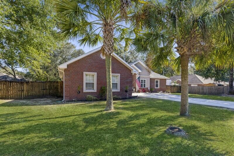 4599 Live Oak Church Road Crestview, FL 32539 - Photo 2 of 34 a backyard of a house with palm trees