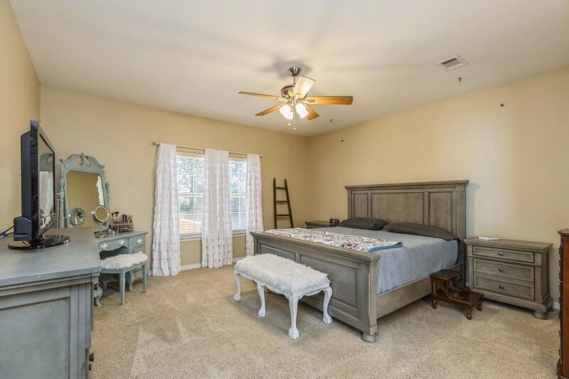4599 Live Oak Church Road Crestview, FL 32539 - Photo 21 of 34 a bedroom with a bed and a chandelier