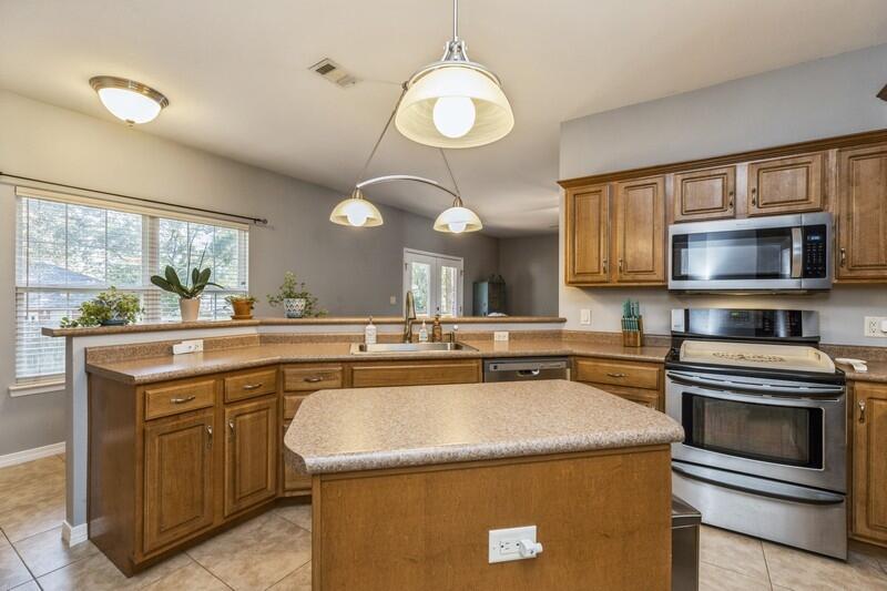4599 Live Oak Church Road Crestview, FL 32539 - Photo 10 of 34 a kitchen with a stove a sink and a microwave
