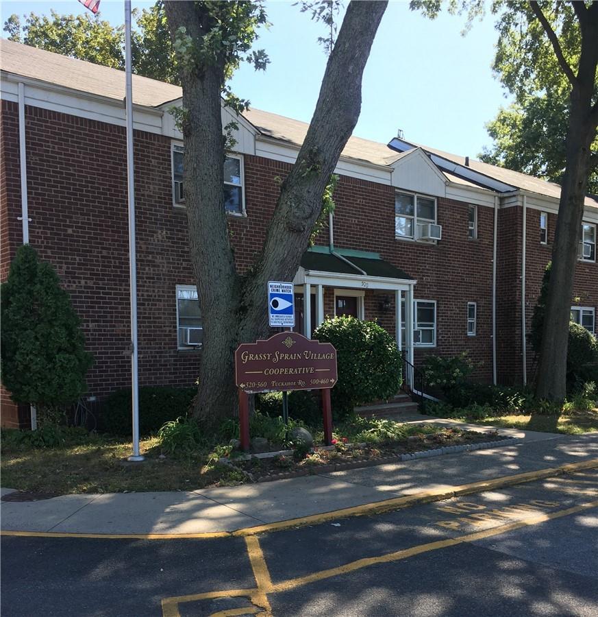 520 Tuckahoe Road, Unit 3A Yonkers, NY 10710 - Photo 1 of 1 a view of a brick house with a yard plants and large tree