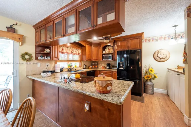 a kitchen with stainless steel appliances granite countertop a sink and cabinets