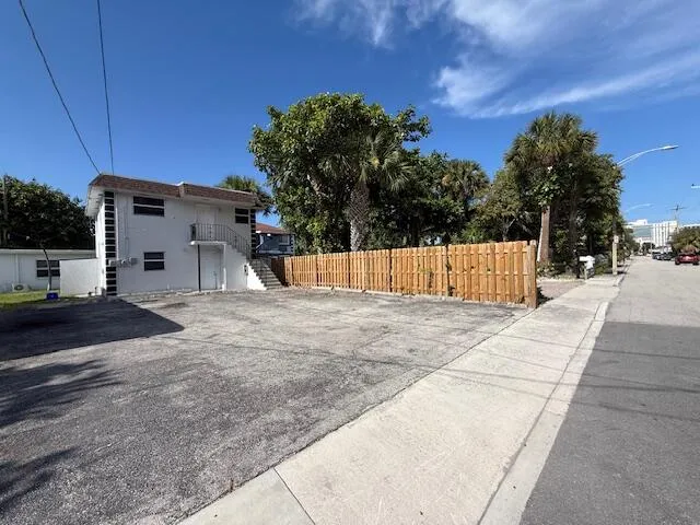 a kitchen with a refrigerator and a stove top oven