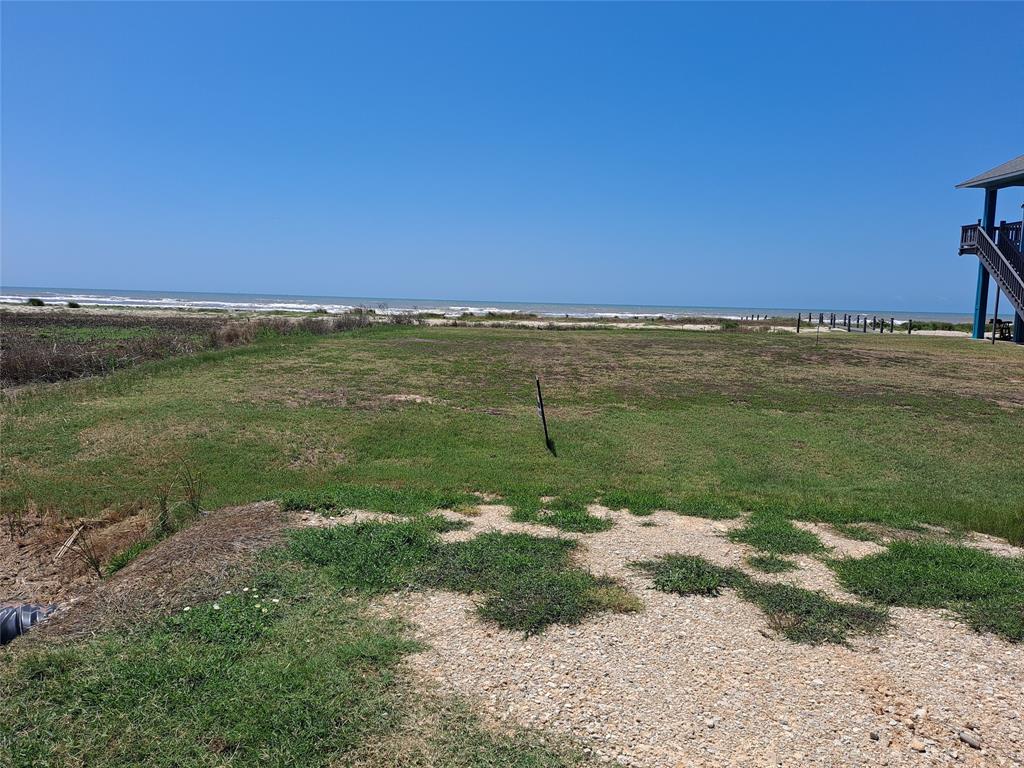 a view of a field with an ocean