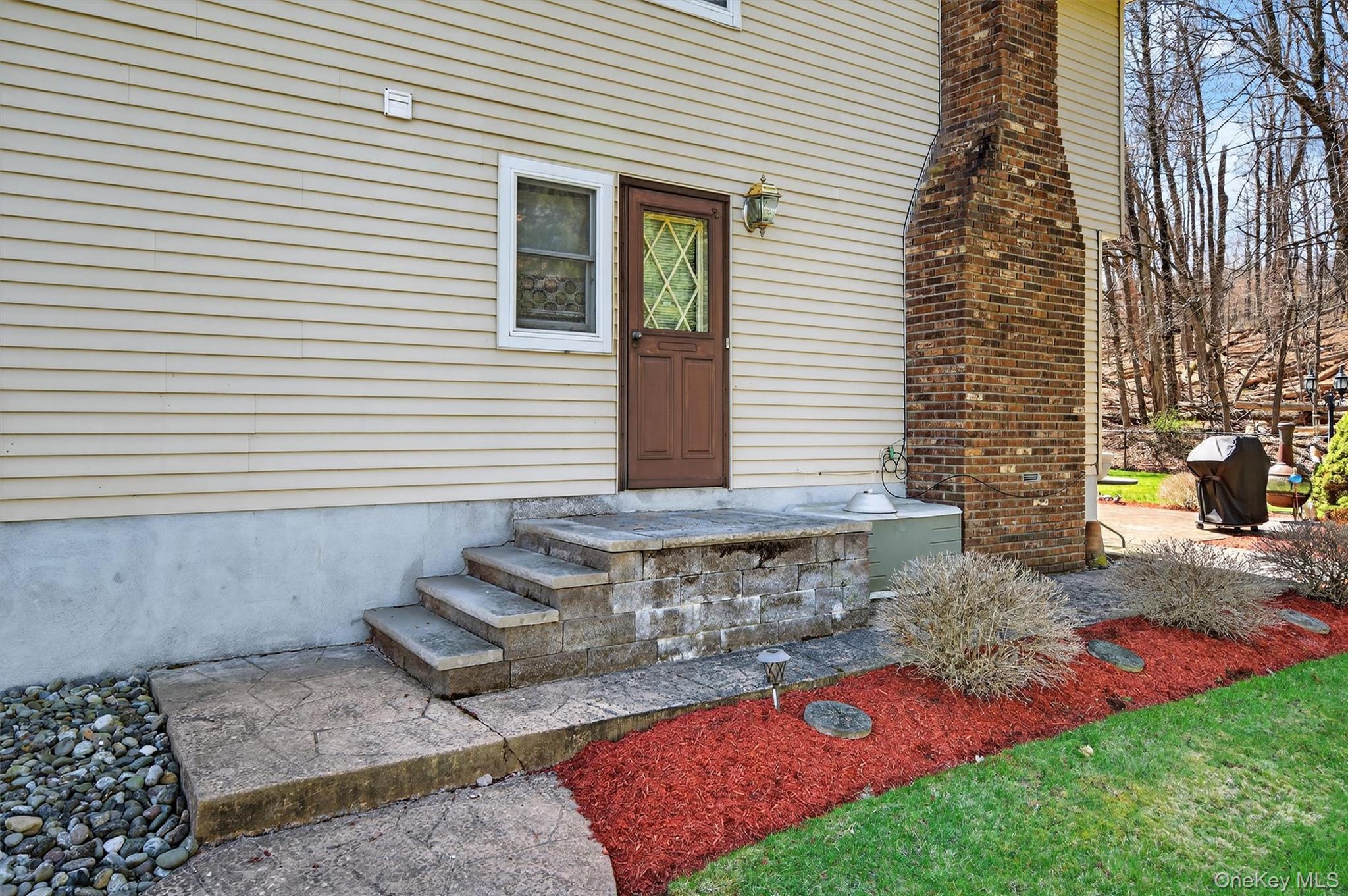 449 West Mombasha Road Monroe, NY 10950 - Photo 25 of 39 a view of a house with a yard and a garage