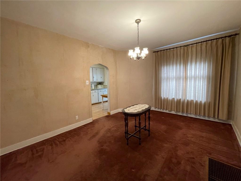 2209 Hawthorne Avenue Pittsburgh, PA 15218 - Photo 7 of 21 an empty room with windows and wooden floor