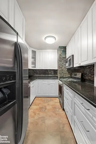 a large kitchen with cabinets and stainless steel appliances