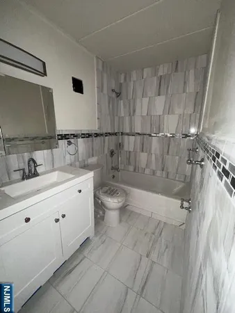 a bathroom with a double vanity sink toilet and shower