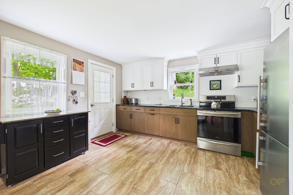 70 Neponset Street Canton, MA 02021 - Photo 10 of 39 a kitchen with stainless steel appliances granite countertop a stove a sink dishwasher and a refrigerator