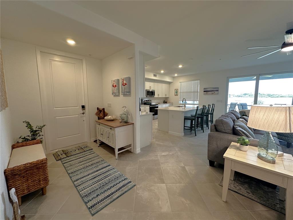 14192 Poppy Fld Loop, Unit 5011 Punta Gorda, FL 33955 - Photo 1 of 48 a living room with furniture and a table