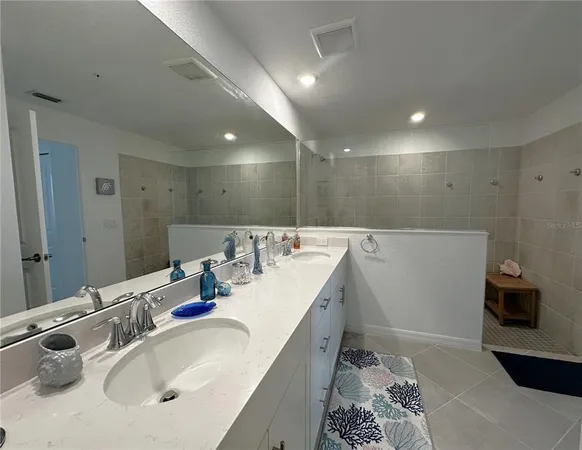 a bathroom with a double vanity sink and a mirror