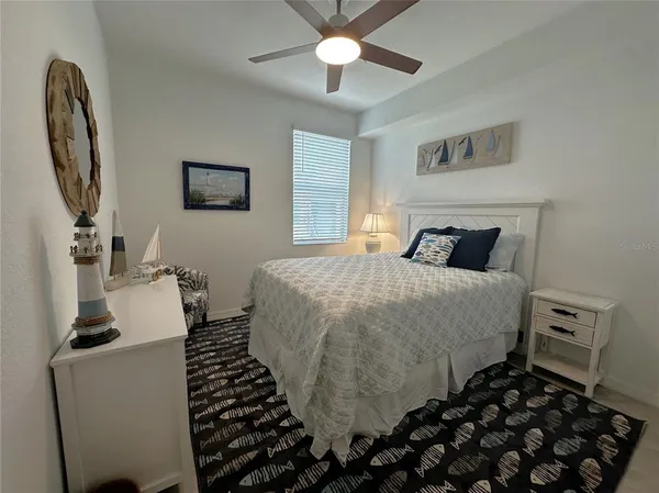 a bedroom with a bed and a mirror on the dresser