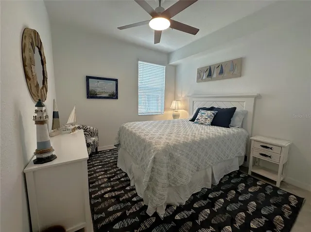 a bedroom with a bed and a mirror on the dresser