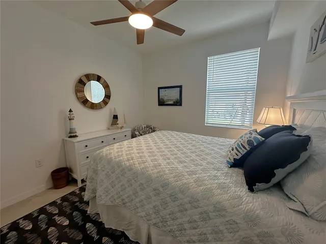 a bedroom with a bed and a chair