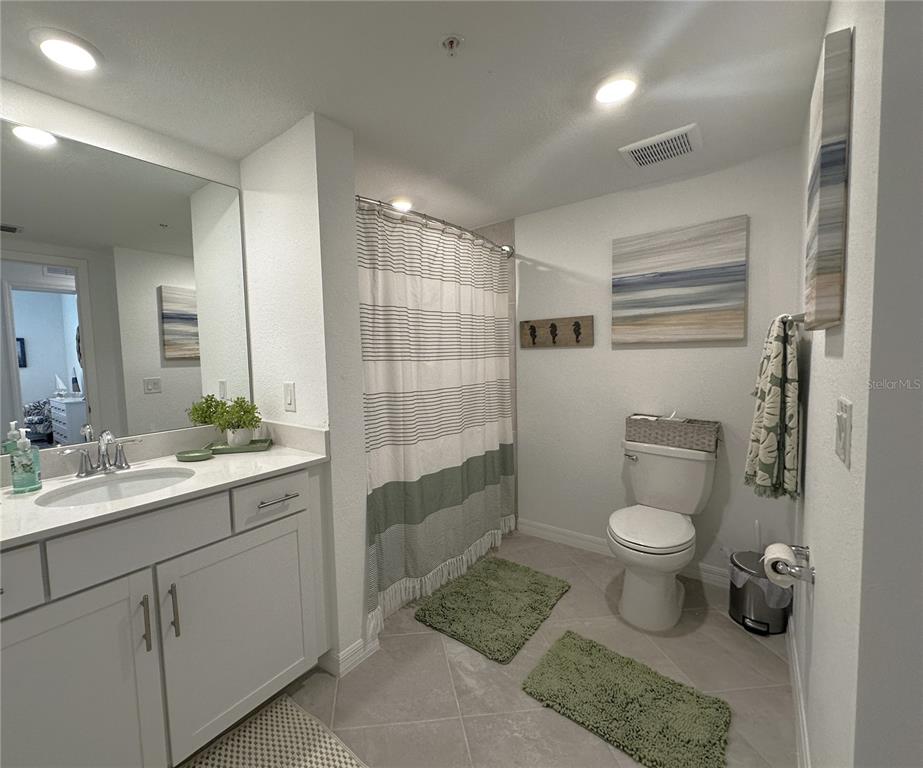 14192 Poppy Fld Loop, Unit 5011 Punta Gorda, FL 33955 - Photo 17 of 48 a bathroom with a sink toilet and shower
