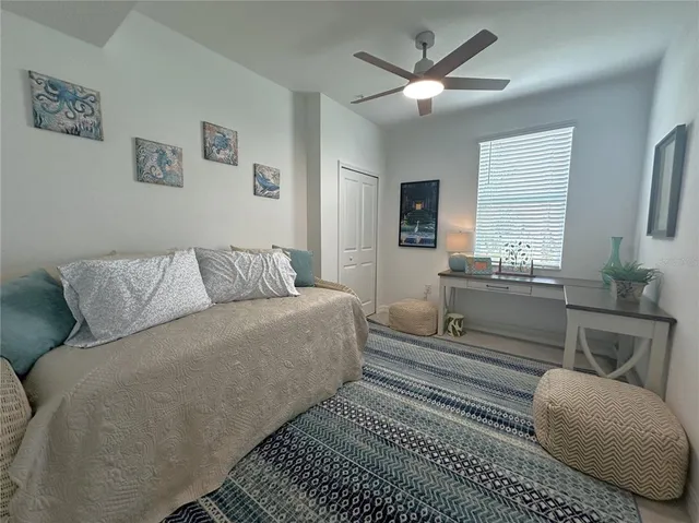 a living room with furniture a couch and a ceiling fan
