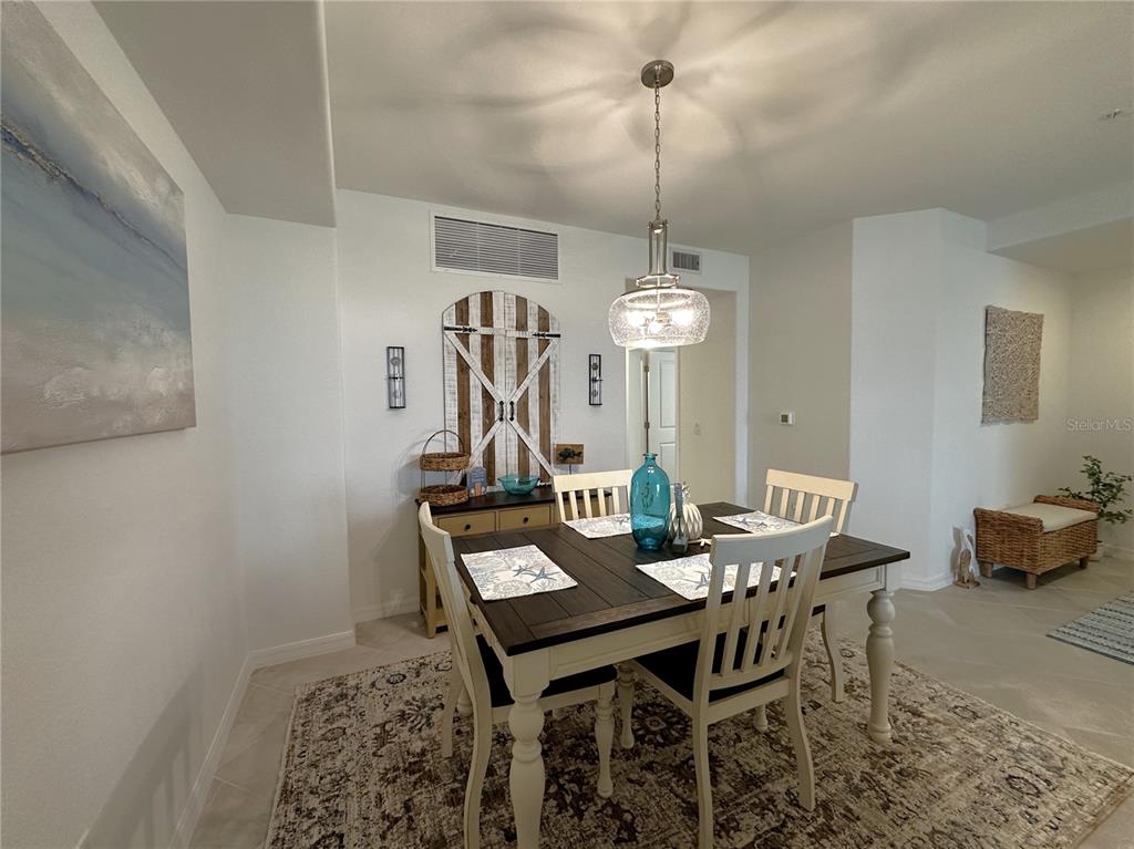 14192 Poppy Fld Loop, Unit 5011 Punta Gorda, FL 33955 - Photo 4 of 48 a view of a dining room with furniture