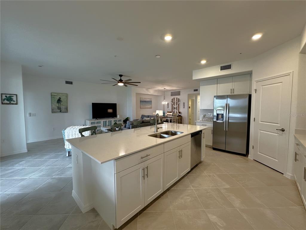 14192 Poppy Fld Loop, Unit 5011 Punta Gorda, FL 33955 - Photo 8 of 48 a large kitchen with kitchen island a sink stainless steel appliances and cabinets