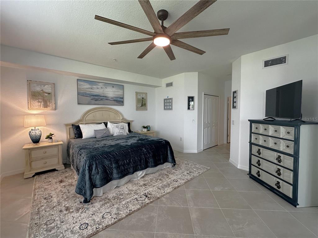 14192 Poppy Fld Loop, Unit 5011 Punta Gorda, FL 33955 - Photo 10 of 48 a bedroom with a bed and a television
