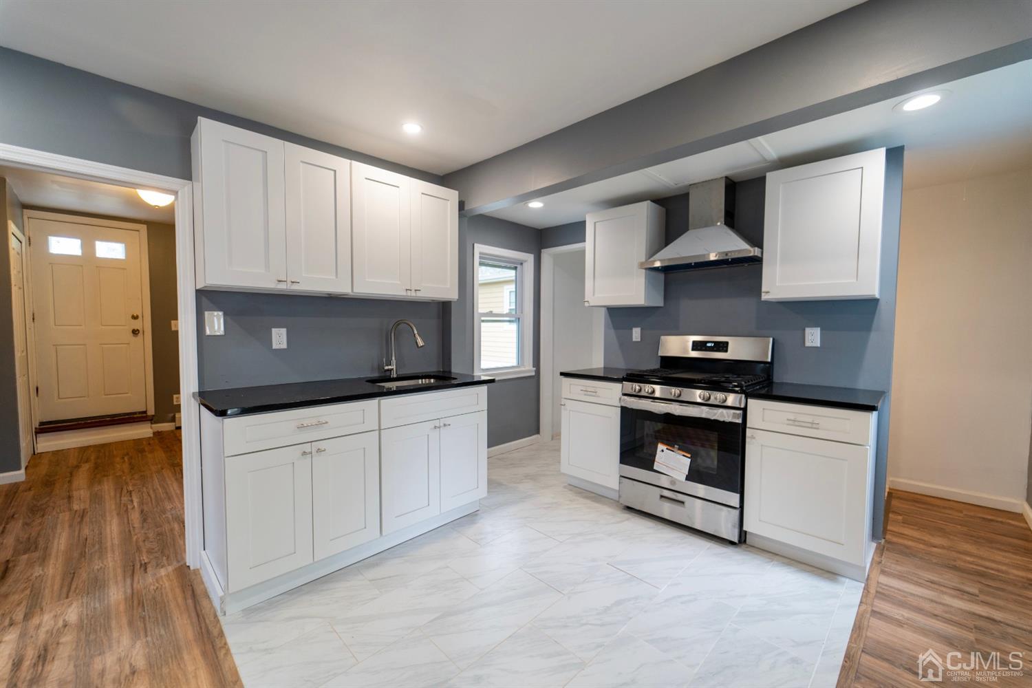 15 Middlesex Avenue Old Bridge, NJ 07735 - Photo 11 of 30 a kitchen with stainless steel appliances a sink a stove and cabinets