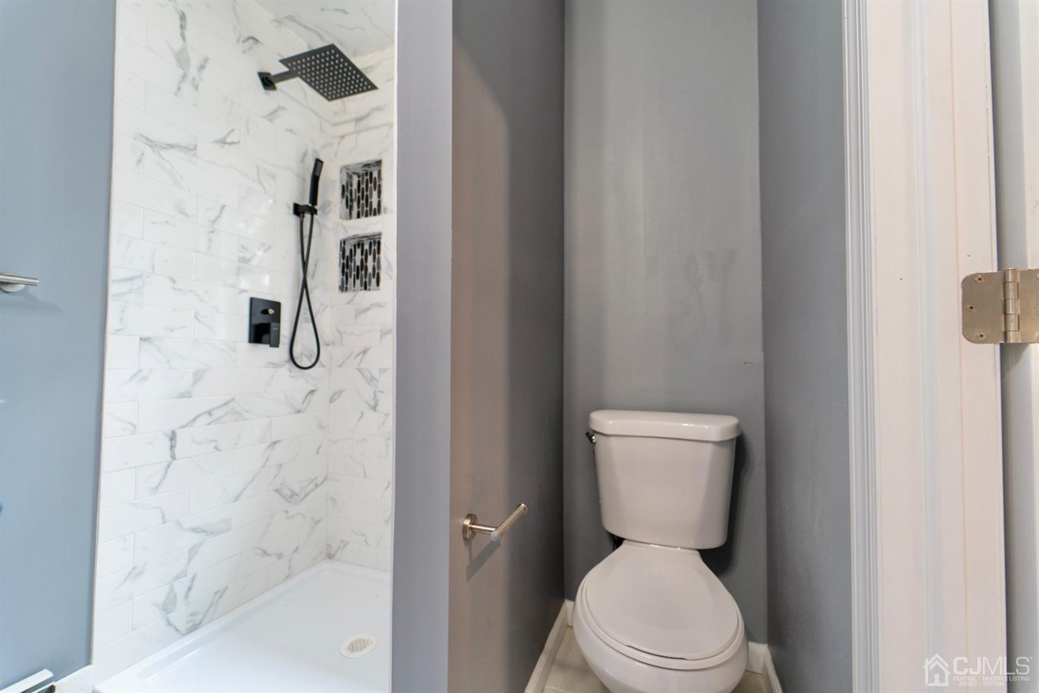 15 Middlesex Avenue Old Bridge, NJ 07735 - Photo 14 of 30 a white toilet sitting next to a bathroom sink