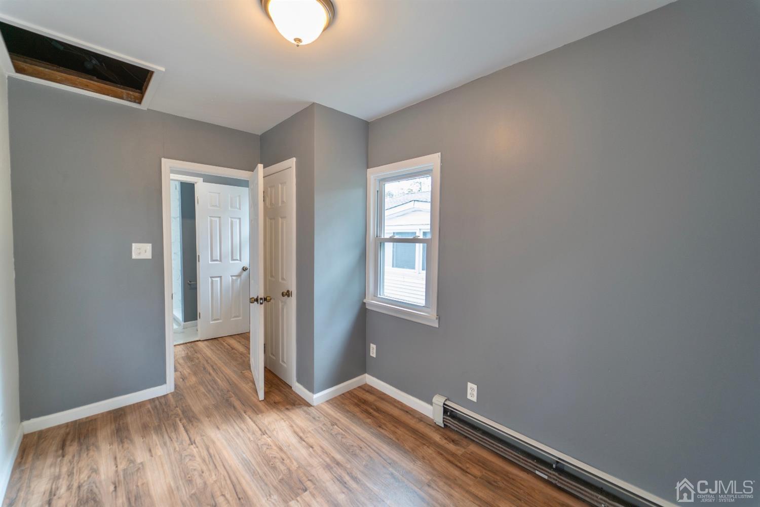 15 Middlesex Avenue Old Bridge, NJ 07735 - Photo 15 of 30 an empty room with wooden floor and windows