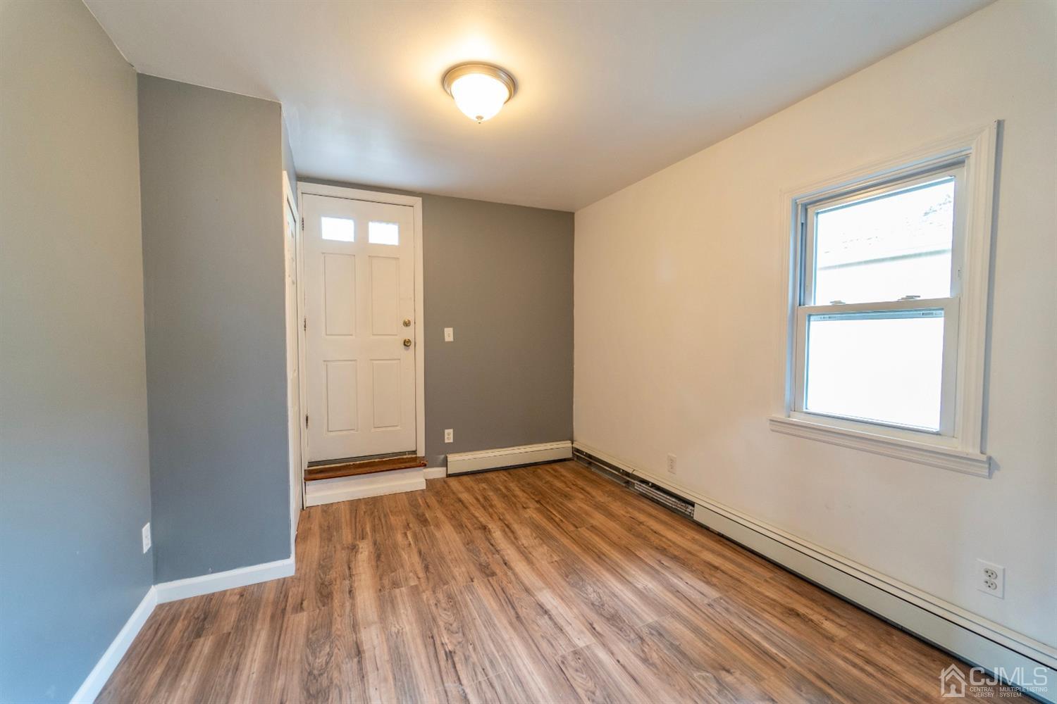 15 Middlesex Avenue Old Bridge, NJ 07735 - Photo 19 of 30 an empty room with wooden floor and windows