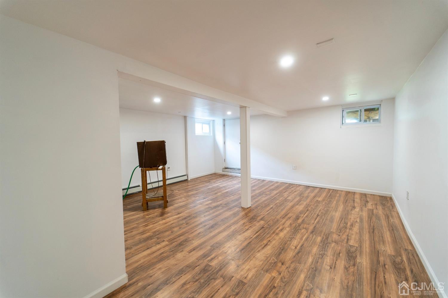 15 Middlesex Avenue Old Bridge, NJ 07735 - Photo 21 of 30 a view of an empty room with wooden floor and a window