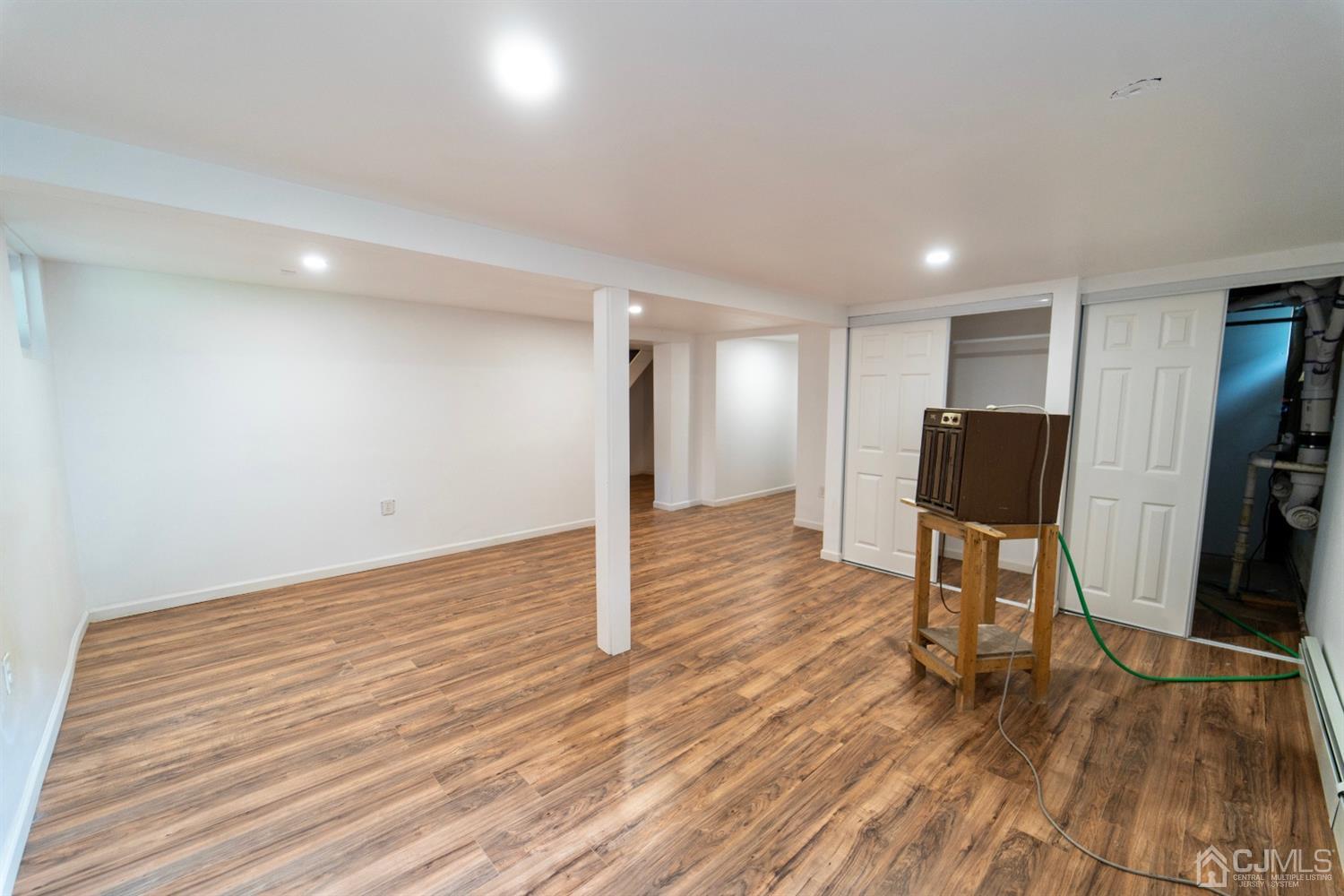 15 Middlesex Avenue Old Bridge, NJ 07735 - Photo 22 of 30 a view of a livingroom with wooden floor and a flat screen tv