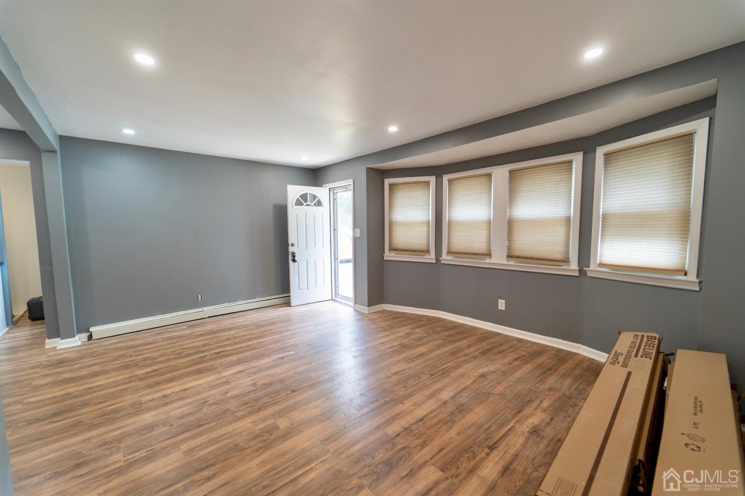 15 Middlesex Avenue Old Bridge, NJ 07735 - Photo 5 of 30 a view of an empty room with wooden floor and a window