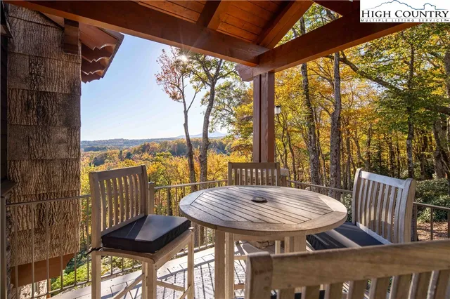 a view of a balcony with table and chairs