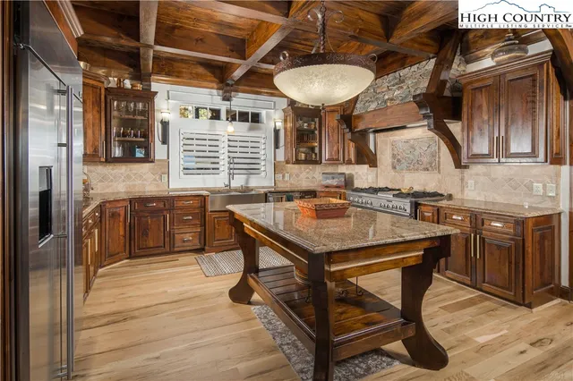 a kitchen with a counter space a sink appliances and cabinets