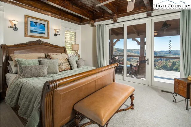 a bedroom with furniture and a large window