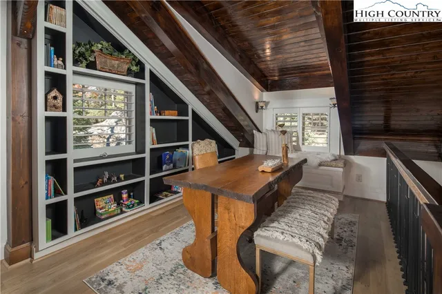 a living room with furniture a rug and a book shelf