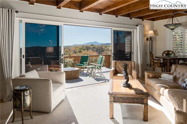 a living room with fireplace furniture and a floor to ceiling window