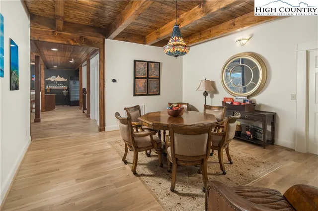 a dining room with livingroom view and wooden floor