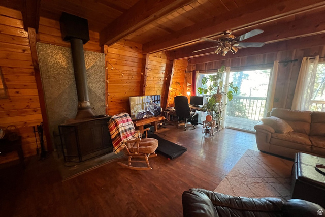 140 East Rim Road Duck Creek Village, UT 84762 - Photo 3 of 45 Living room with wood walls, wood finished floors, a wooden ceiling with exposed beams, an office area, and a ceiling fan