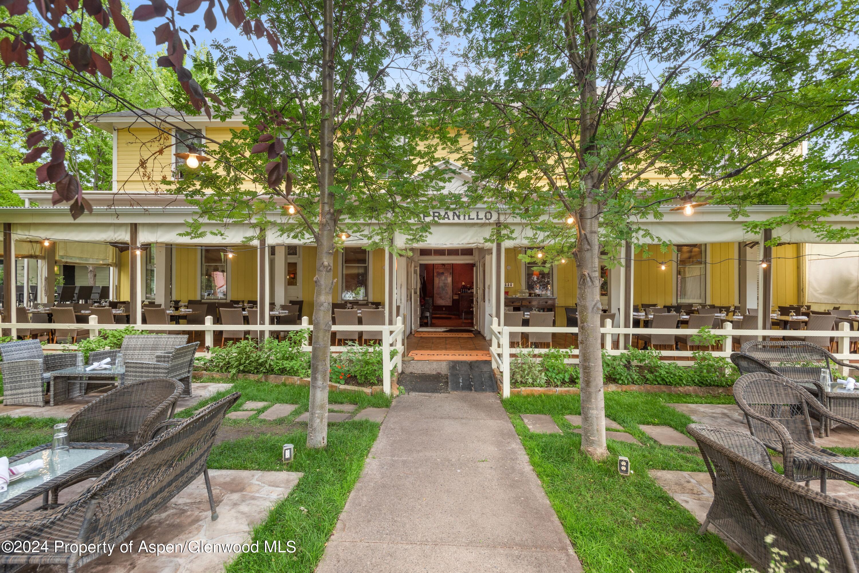 a front view of a house with a yard table and chairs