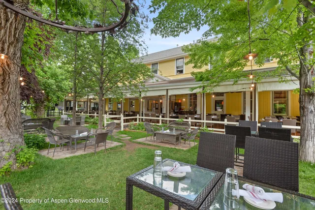 a view of a house with backyard sitting area and garden