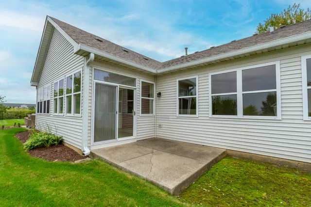 a front view of a house with a garden and trees