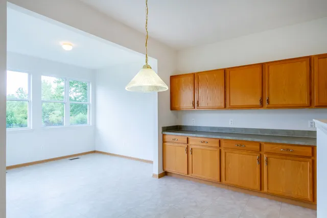 a kitchen that has a sink a stove and a window
