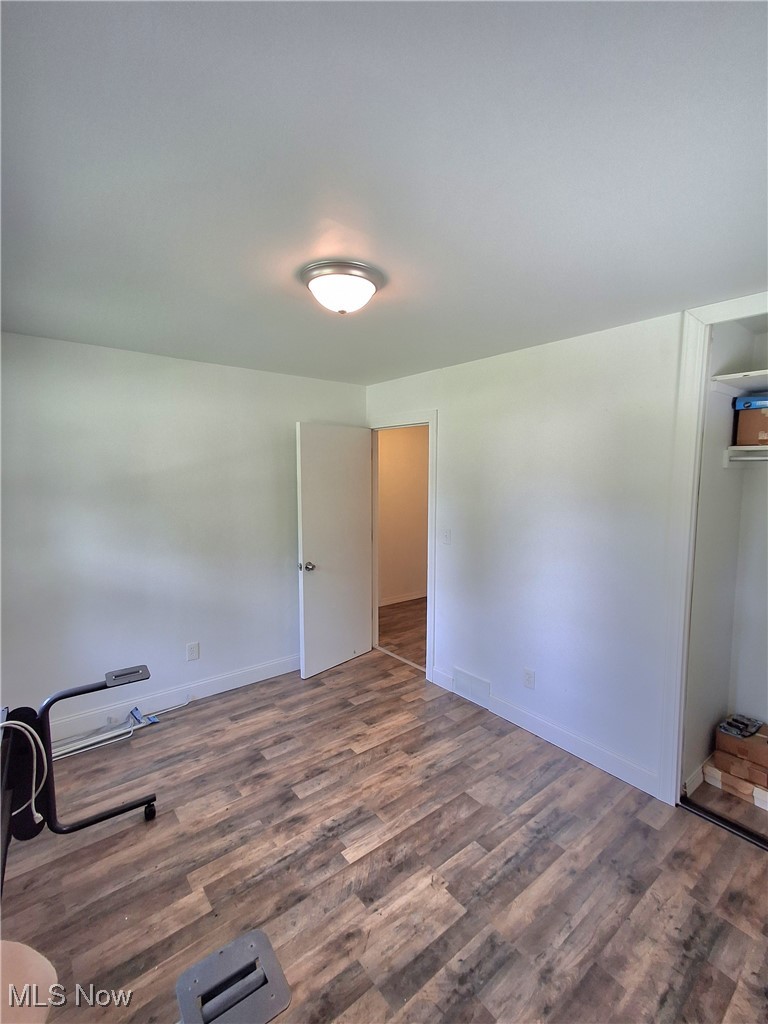5476 Chippewa Road Medina, OH 44215 - Photo 18 of 30 Empty room featuring dark wood-type flooring and baseboards