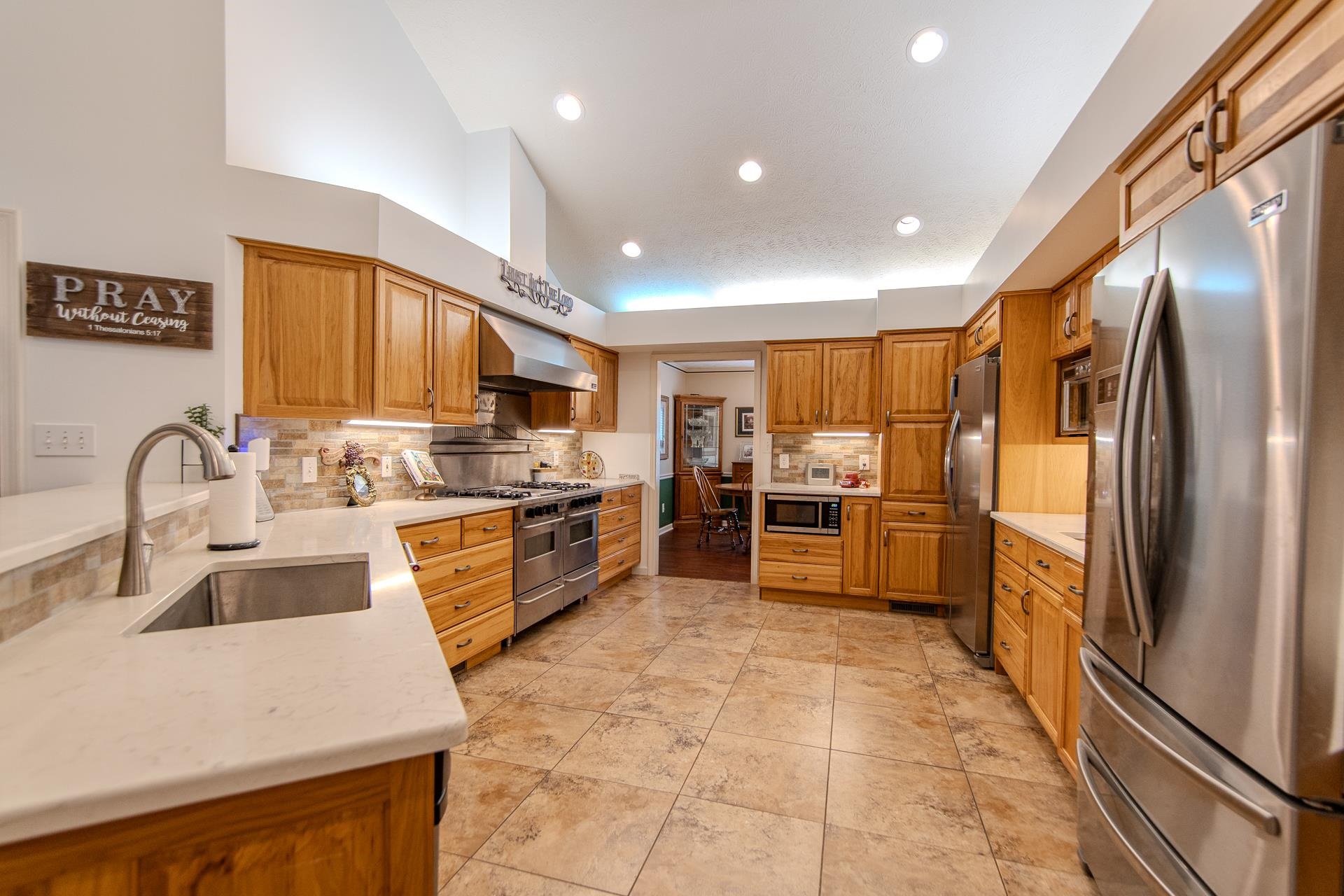 485 Robin Hood Loop Savannah, TN 38372 - Photo 11 of 40 a kitchen with stainless steel appliances a refrigerator sink and cabinets