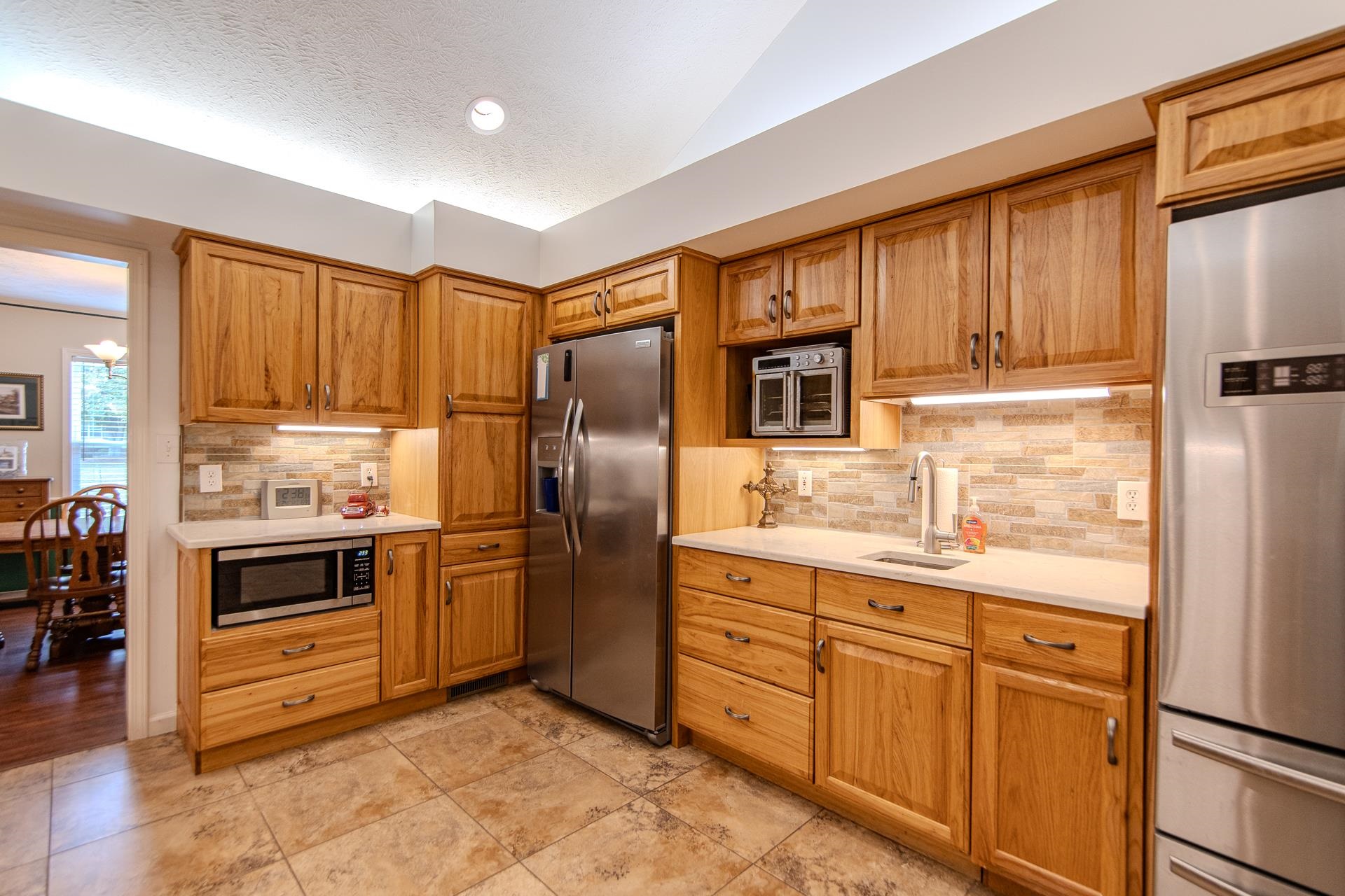 485 Robin Hood Loop Savannah, TN 38372 - Photo 12 of 40 a kitchen with stainless steel appliances a refrigerator sink and cabinets