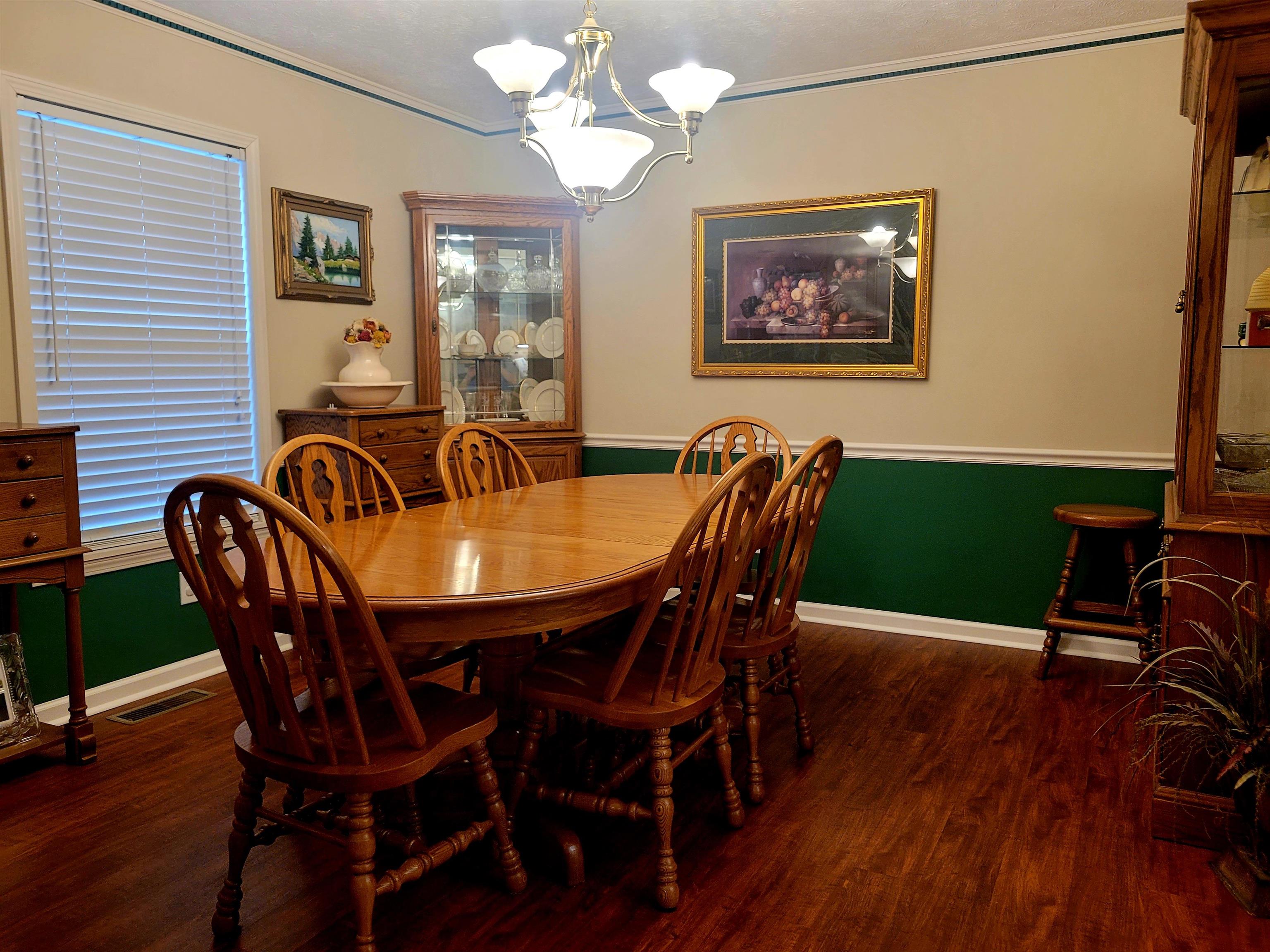 485 Robin Hood Loop Savannah, TN 38372 - Photo 14 of 40 a view of a dining room with furniture wooden floor and chandelier