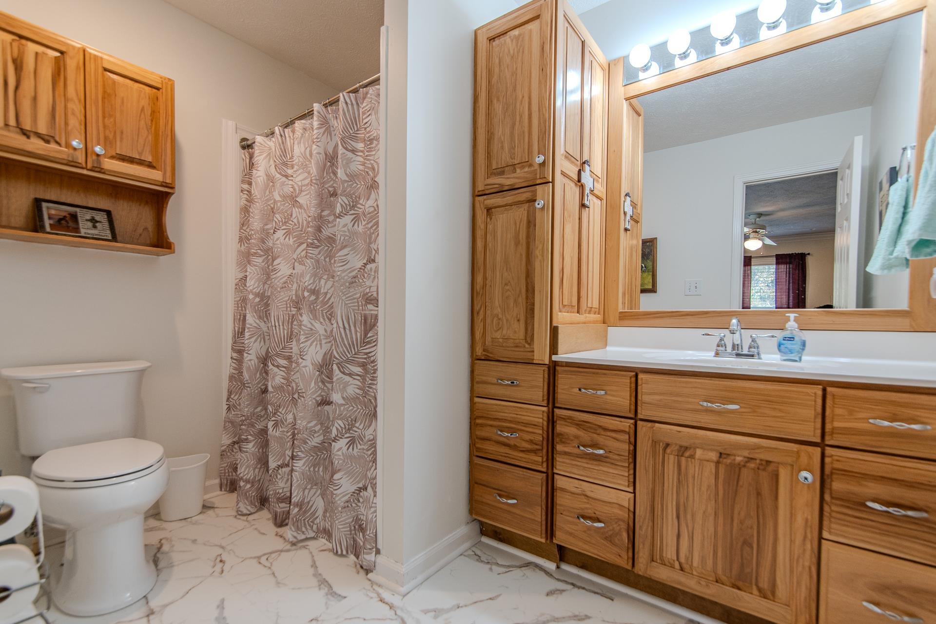 485 Robin Hood Loop Savannah, TN 38372 - Photo 15 of 40 a bathroom with a granite countertop toilet a sink and a mirror